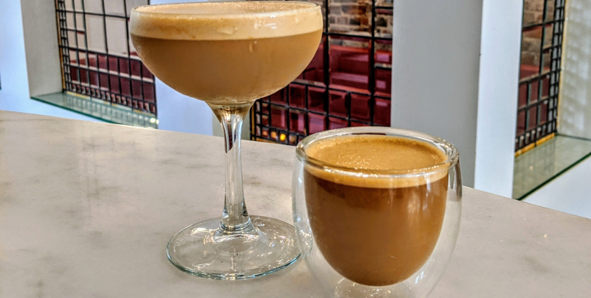 Two lattes served in a cocktail glasses